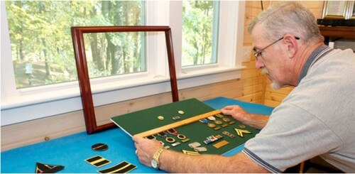 Dennis Carney, owner of US Shadows assembling a shadowbox